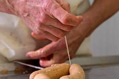 Hands preparing artisan sausage