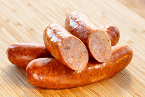 Smoked Andouille sausages on a wooden board
