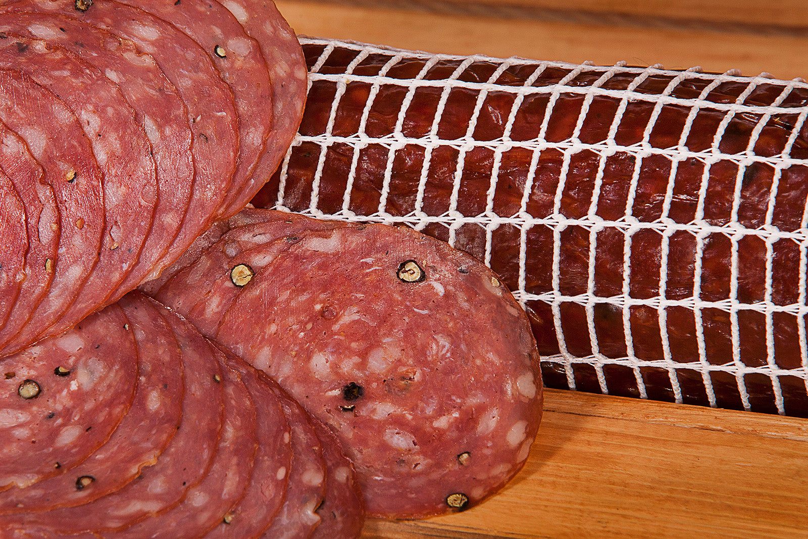 Red Wine Black Pepper Salami slices and whole salami